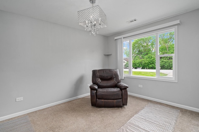 sitting room with a chandelier, baseboards, and carpet floors
