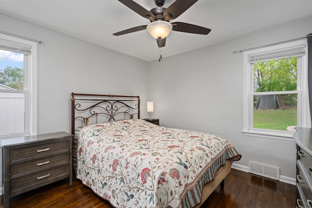 bedroom with dark wood-style flooring, baseboards, and a ceiling fan