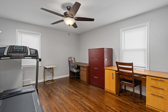 office space featuring wood finished floors, a ceiling fan, and baseboards