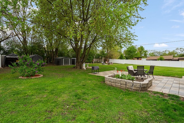 view of yard featuring a storage unit, a patio area, and an outdoor structure
