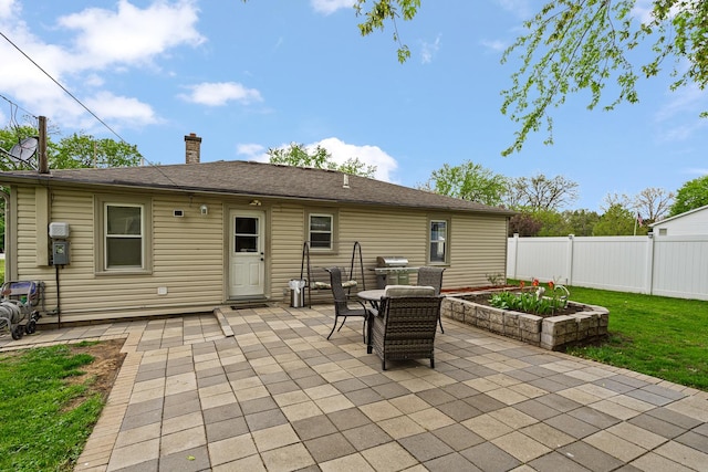 back of house with a patio, fence, a chimney, and outdoor dining area