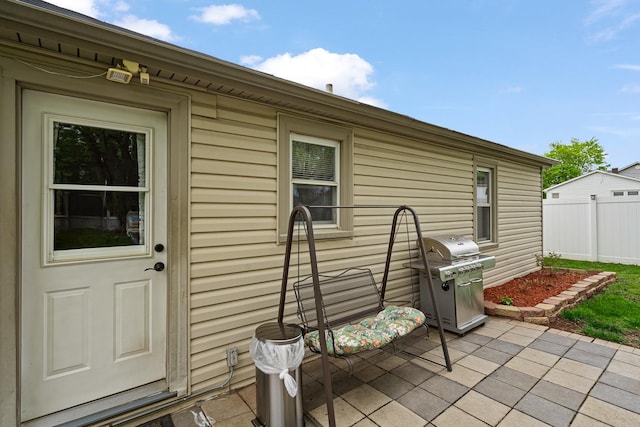 view of patio with grilling area and fence