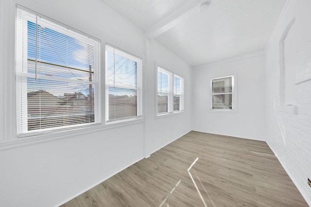 unfurnished sunroom with beamed ceiling