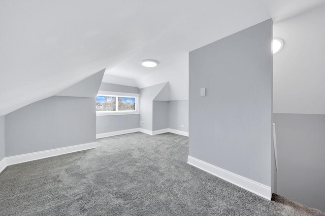 bonus room featuring vaulted ceiling, carpet, and baseboards