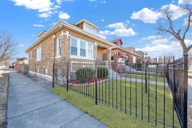 view of front facade featuring a residential view, brick siding, fence, and a front lawn