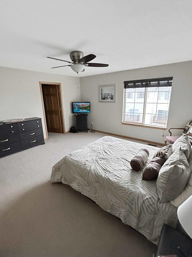 carpeted bedroom with ceiling fan