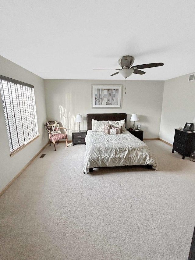 bedroom featuring baseboards, visible vents, and carpet flooring