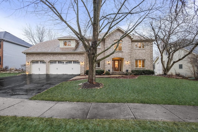 view of front of house with a garage, aphalt driveway, and a front yard