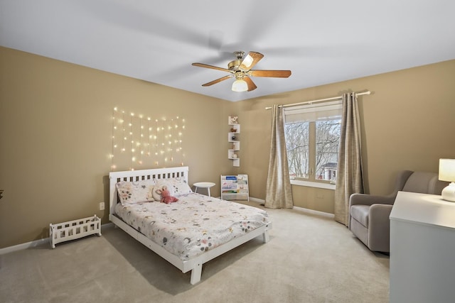 bedroom featuring light carpet, ceiling fan, and baseboards