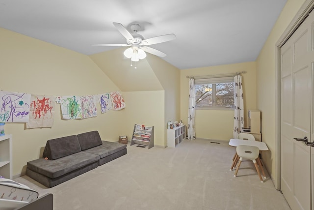 playroom featuring lofted ceiling, a ceiling fan, and light colored carpet