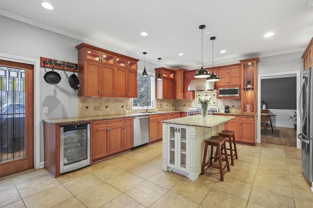 kitchen featuring stainless steel appliances, beverage cooler, a sink, and tasteful backsplash