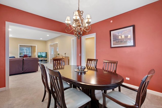 dining space with a chandelier, recessed lighting, light colored carpet, and baseboards