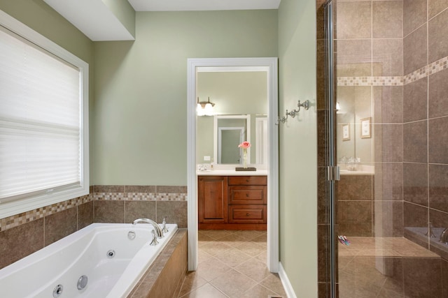 full bathroom with tile patterned flooring, a stall shower, a jetted tub, and vanity