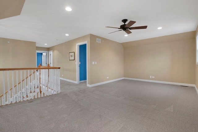 carpeted empty room featuring a ceiling fan, visible vents, recessed lighting, and baseboards