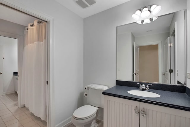 bathroom with vanity, baseboards, visible vents, tile patterned floors, and toilet