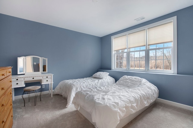 bedroom with visible vents, baseboards, and carpet