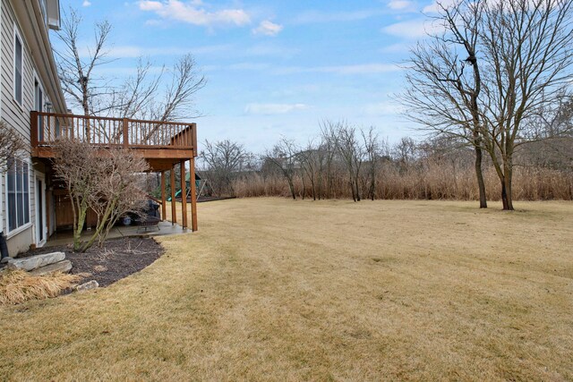 view of yard featuring a wooden deck and stairs