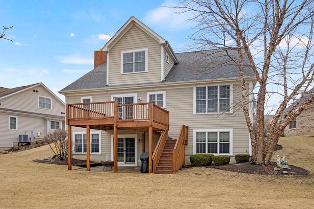 back of house featuring a wooden deck, stairs, roof with shingles, a yard, and a patio area