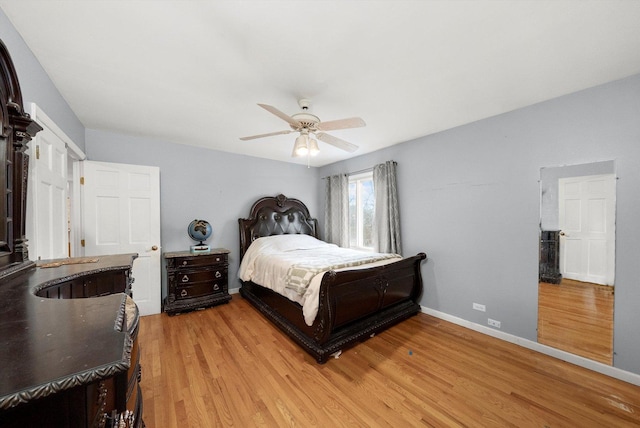 bedroom with a ceiling fan, light wood-style flooring, and baseboards