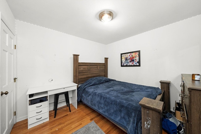 bedroom with wood finished floors and baseboards