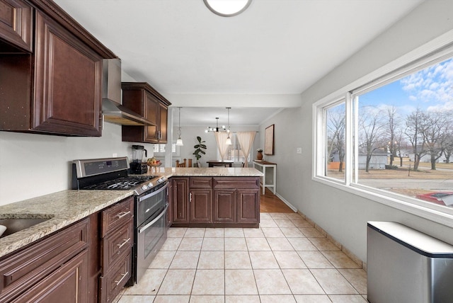 kitchen featuring range with two ovens, a notable chandelier, light tile patterned floors, a peninsula, and wall chimney exhaust hood