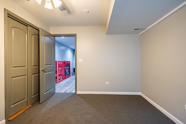 unfurnished bedroom featuring baseboards, visible vents, a ceiling fan, carpet flooring, and a closet