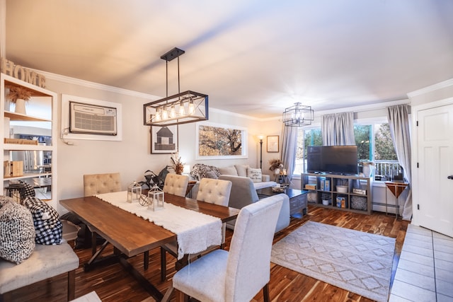 dining space featuring ornamental molding, a baseboard heating unit, an AC wall unit, wood finished floors, and a chandelier