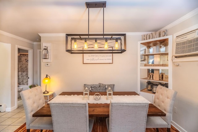 dining room with tile patterned flooring, ornamental molding, baseboards, and a wall mounted AC