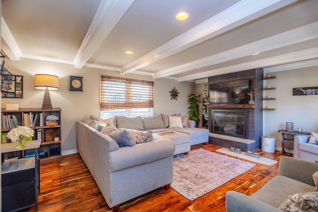 living area featuring crown molding, a fireplace, wood finished floors, beamed ceiling, and baseboards