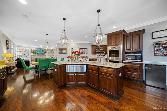 kitchen featuring a warming drawer, a kitchen island, dark wood-style flooring, and stainless steel appliances