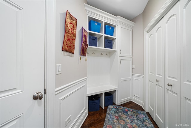 mudroom with a decorative wall, a wainscoted wall, and dark wood-style flooring