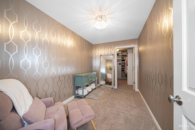 living area with baseboards, light colored carpet, and wallpapered walls