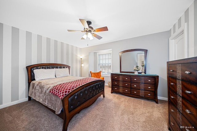 bedroom with baseboards, light carpet, a ceiling fan, and wallpapered walls