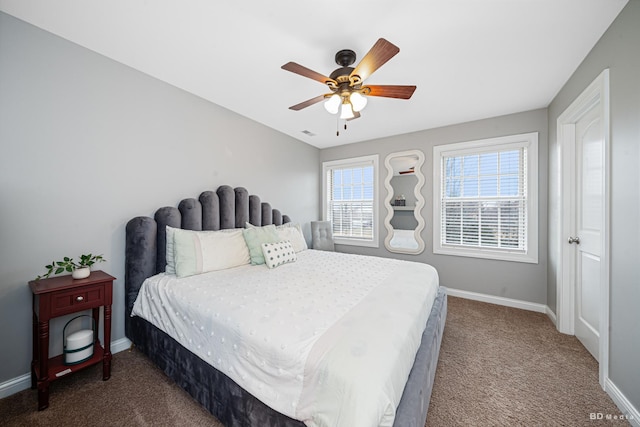 carpeted bedroom with visible vents, a ceiling fan, and baseboards