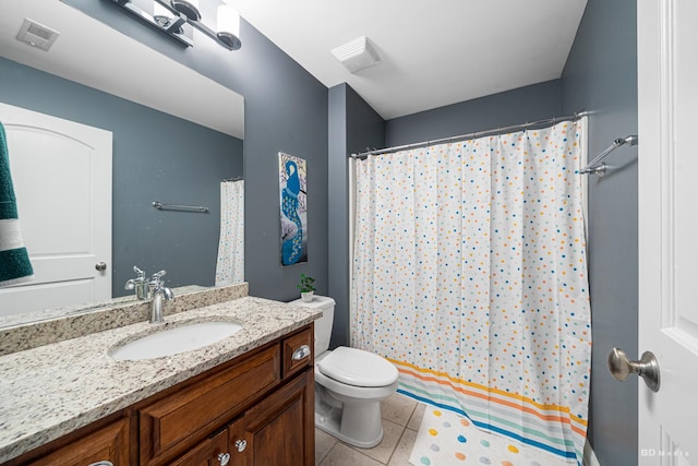 bathroom with tile patterned flooring, toilet, vanity, and visible vents