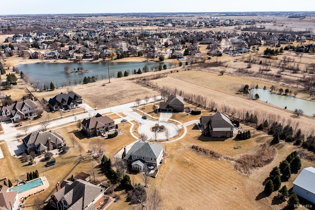 drone / aerial view featuring a residential view and a water view