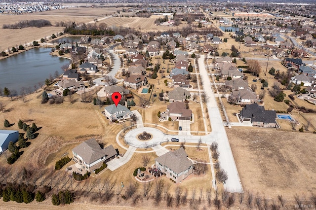 birds eye view of property with a residential view and a water view