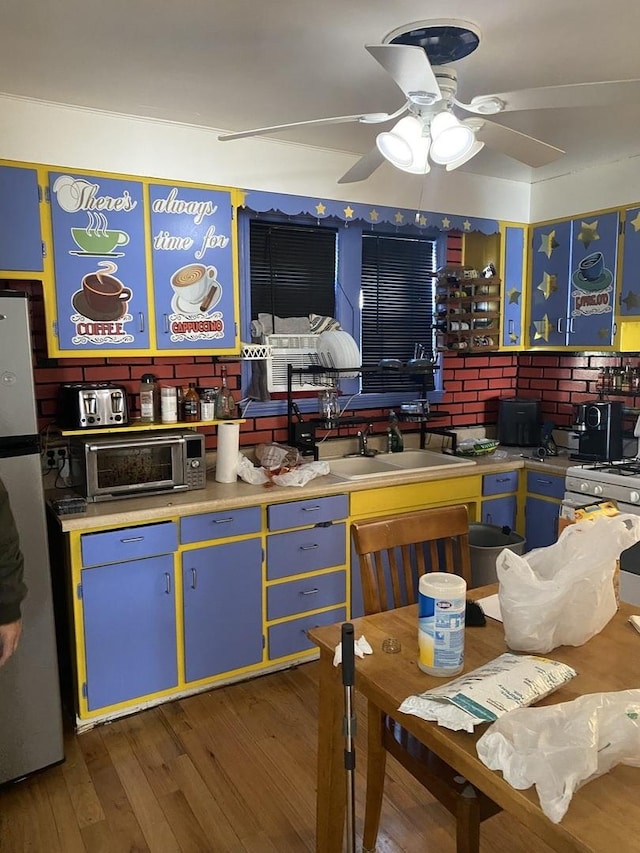 3300 N Osage Ave, Chicago, IL 60634 - interior space featuring wood finished floors, a ceiling fan, a sink, freestanding refrigerator, and a toaster