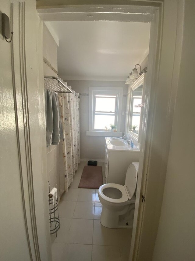 3300 N Osage Ave, Chicago, IL 60634 - full bathroom with tile patterned flooring, toilet, a shower with shower curtain, and vanity
