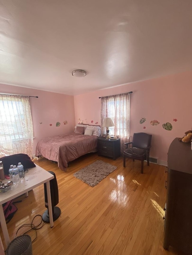 3300 N Osage Ave, Chicago, IL 60634 - bedroom with multiple windows, light wood-style flooring, and visible vents