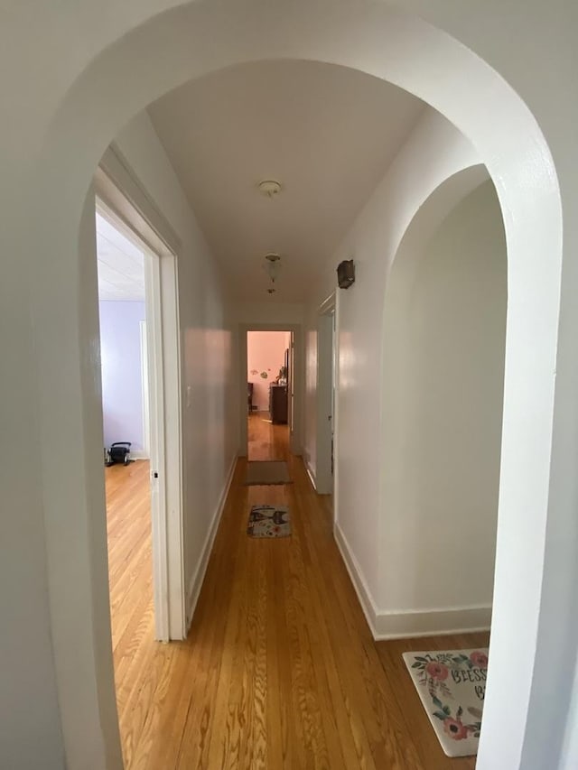 3300 N Osage Ave, Chicago, IL 60634 - corridor with light wood-style floors, baseboards, and arched walkways