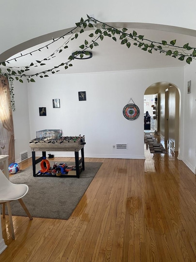 3300 N Osage Ave, Chicago, IL 60634 - interior space featuring arched walkways, baseboards, visible vents, and wood finished floors