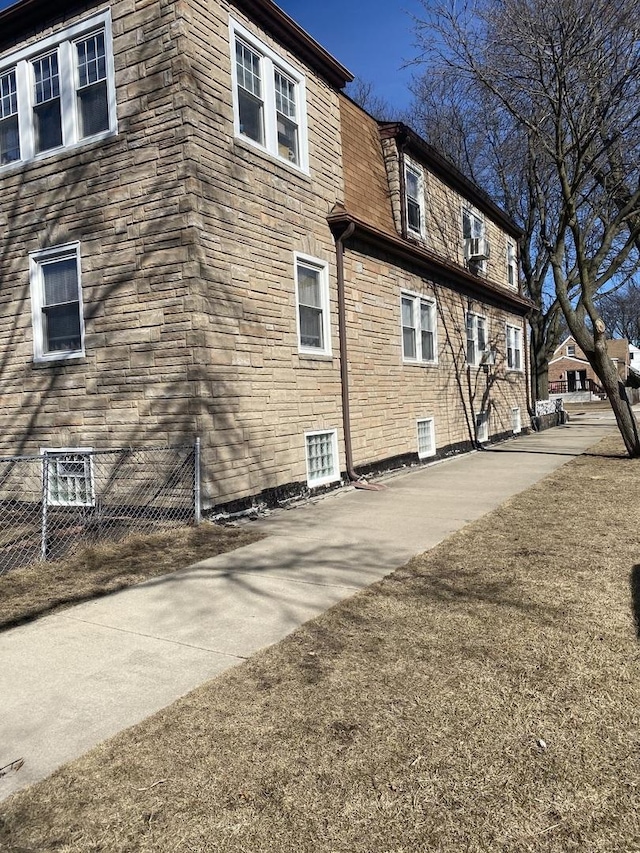 3300 N Osage Ave, Chicago, IL 60634 - view of side of property featuring stone siding and fence