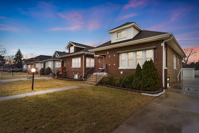 bungalow-style house featuring a front lawn and brick siding