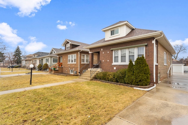 bungalow with brick siding, a residential view, and a front yard