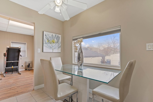 dining room with baseboards, ceiling fan, and tile patterned flooring