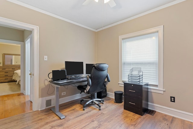 office space featuring visible vents, baseboards, light wood-style floors, and ornamental molding