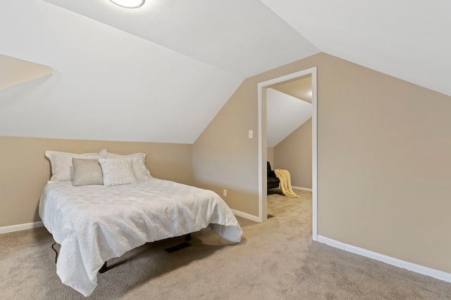 bedroom featuring vaulted ceiling, baseboards, and light carpet