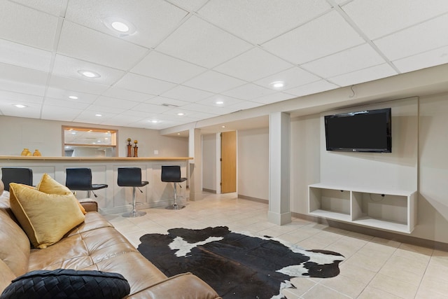 living room featuring light tile patterned floors, baseboards, recessed lighting, a paneled ceiling, and a dry bar