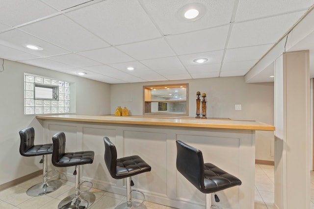 bar featuring light tile patterned floors, recessed lighting, and a dry bar